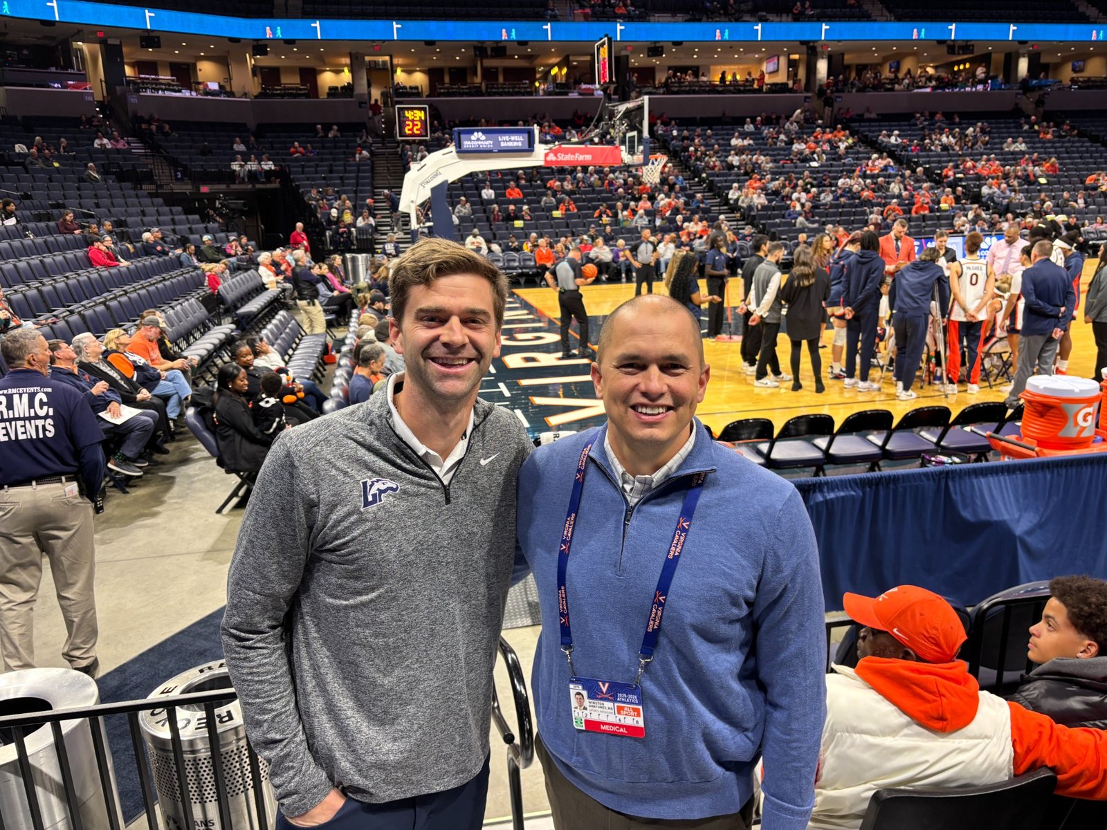 Dr. Gwathmey at a Virginia women's basketball game with a fellow sports medicine physician